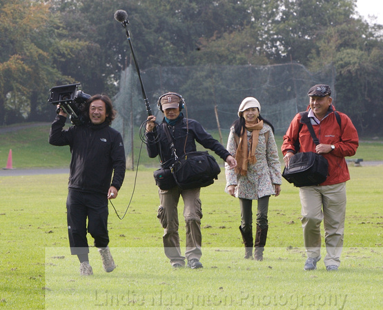 Film crew in the out-field after chasing out to find the hammer!